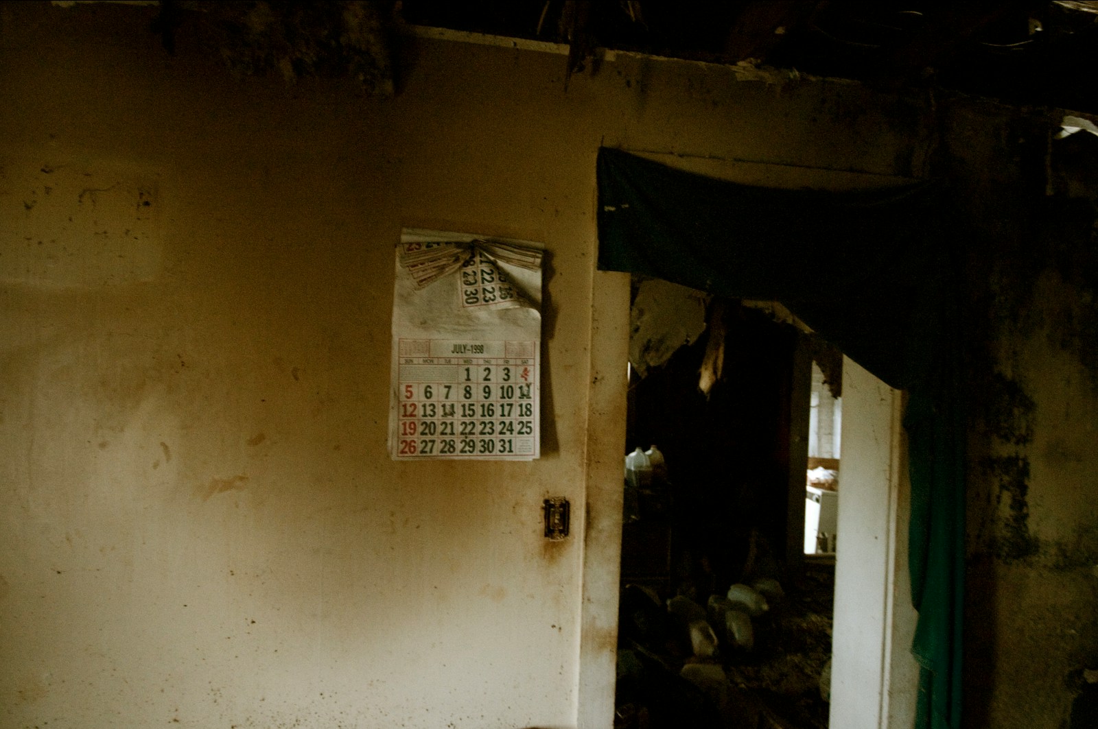 a room with a door and a sign on the wall with homeowners insurance that covers water damage