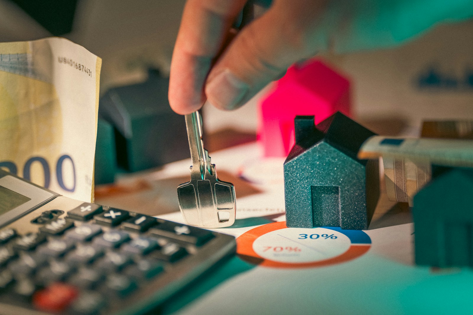 A person putting money into a calculator symbolizing landlord and renters insurance