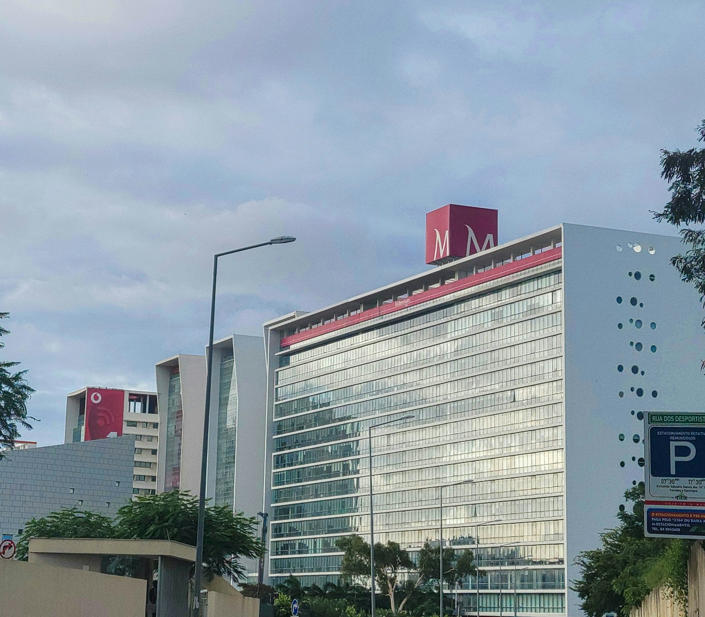 a tall building with commercial property insurance and a red sign on top of it